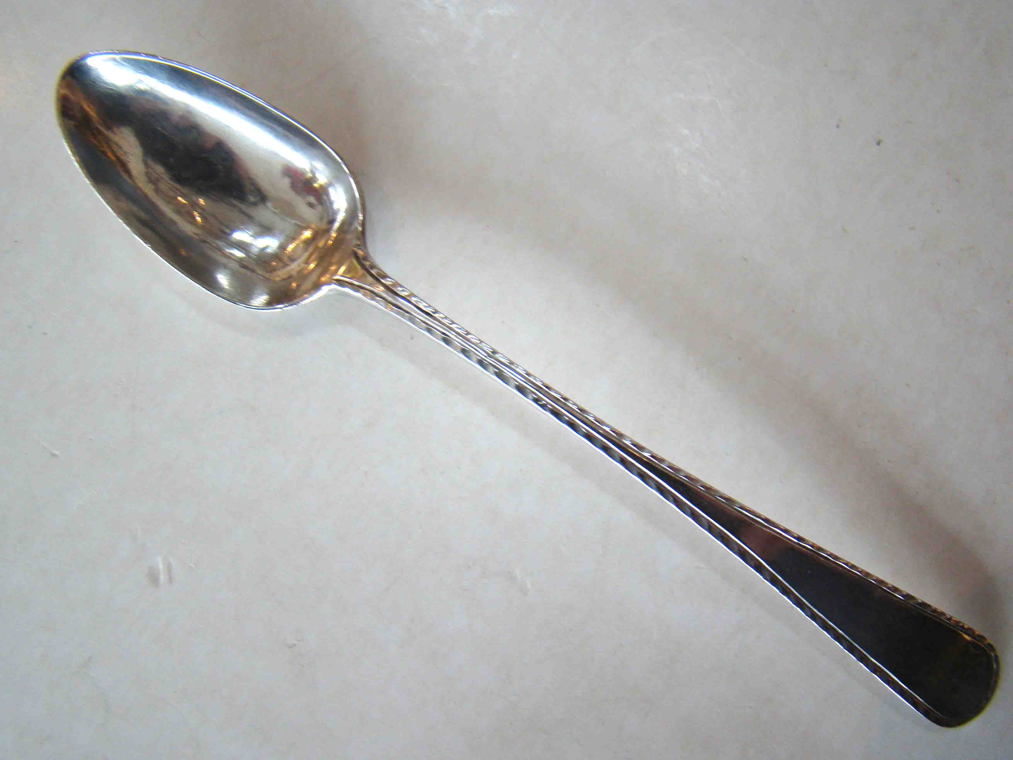 A fine silver teaspoon by Boston silversmith BENJAMIN BURT (1729-1805) circa 1775-1780